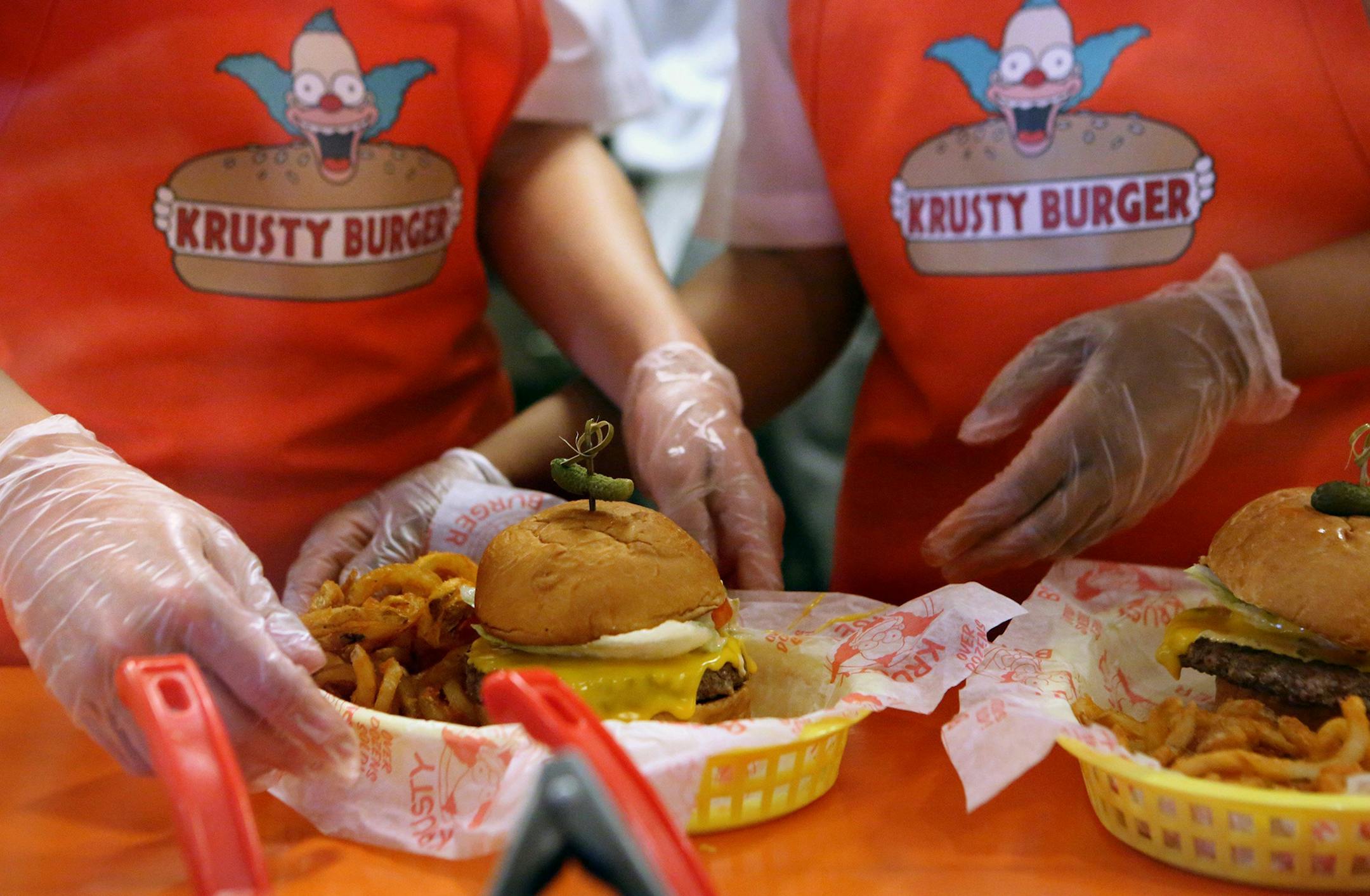 Krusty Burger employees prepare a burger at the Krusty Burger in Universal Orlando, June 14, 2013. (Megan May/Orlando Sentinel/MCT) ORG XMIT: 1140067