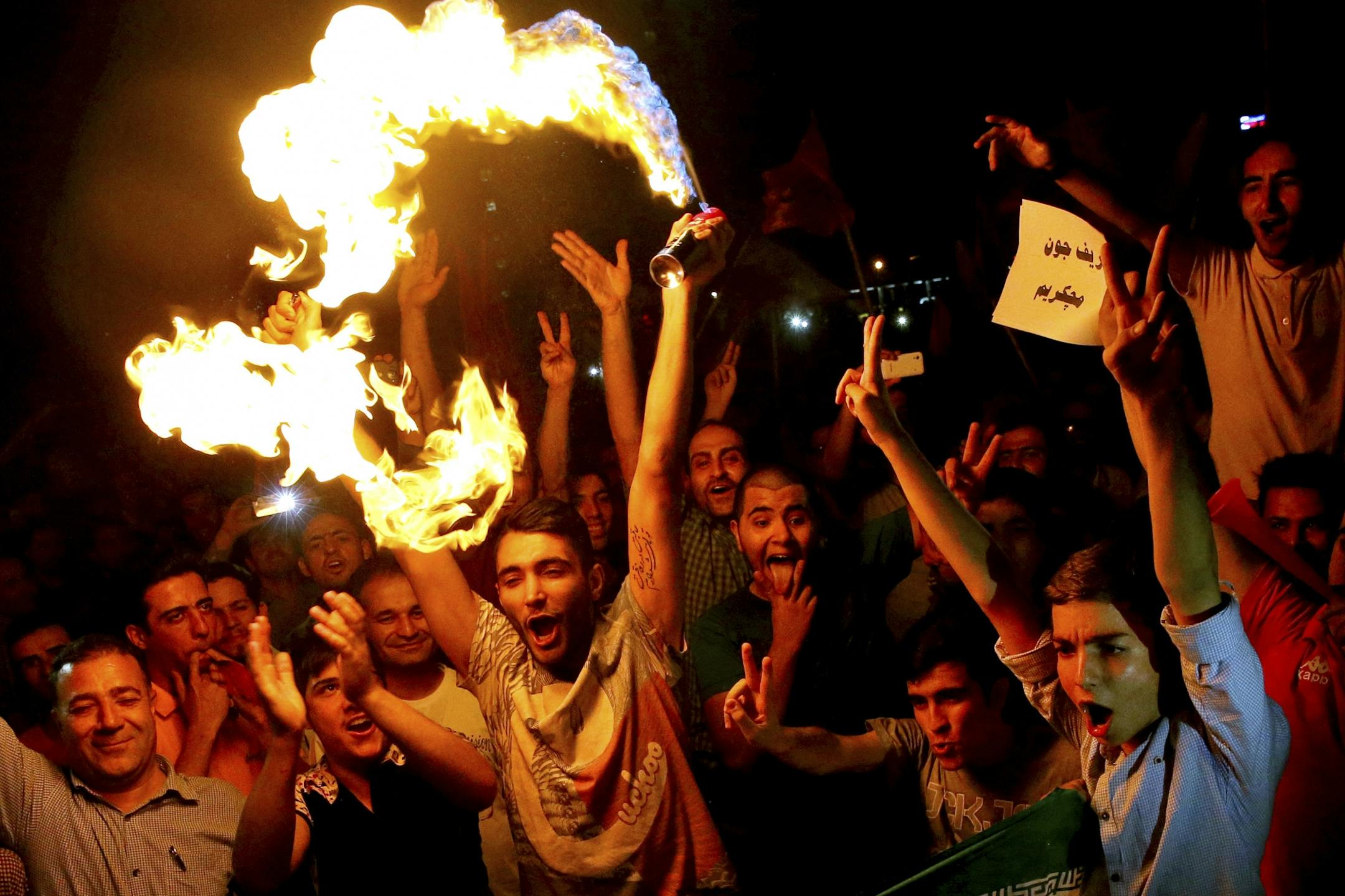 Iranians celebrate following a landmark nuclear deal in Tehran, Iran, Tuesday, July 14, 2015. Overcoming decades of hostility, Iran, the United States, and five other world powers struck a historic accord Tuesday to check Tehran's nuclear efforts short of building a bomb. The agreement could give Iran access to billions in frozen assets and oil revenue, stave off more U.S. military action in the Middle East and reshape the tumultuous region.
