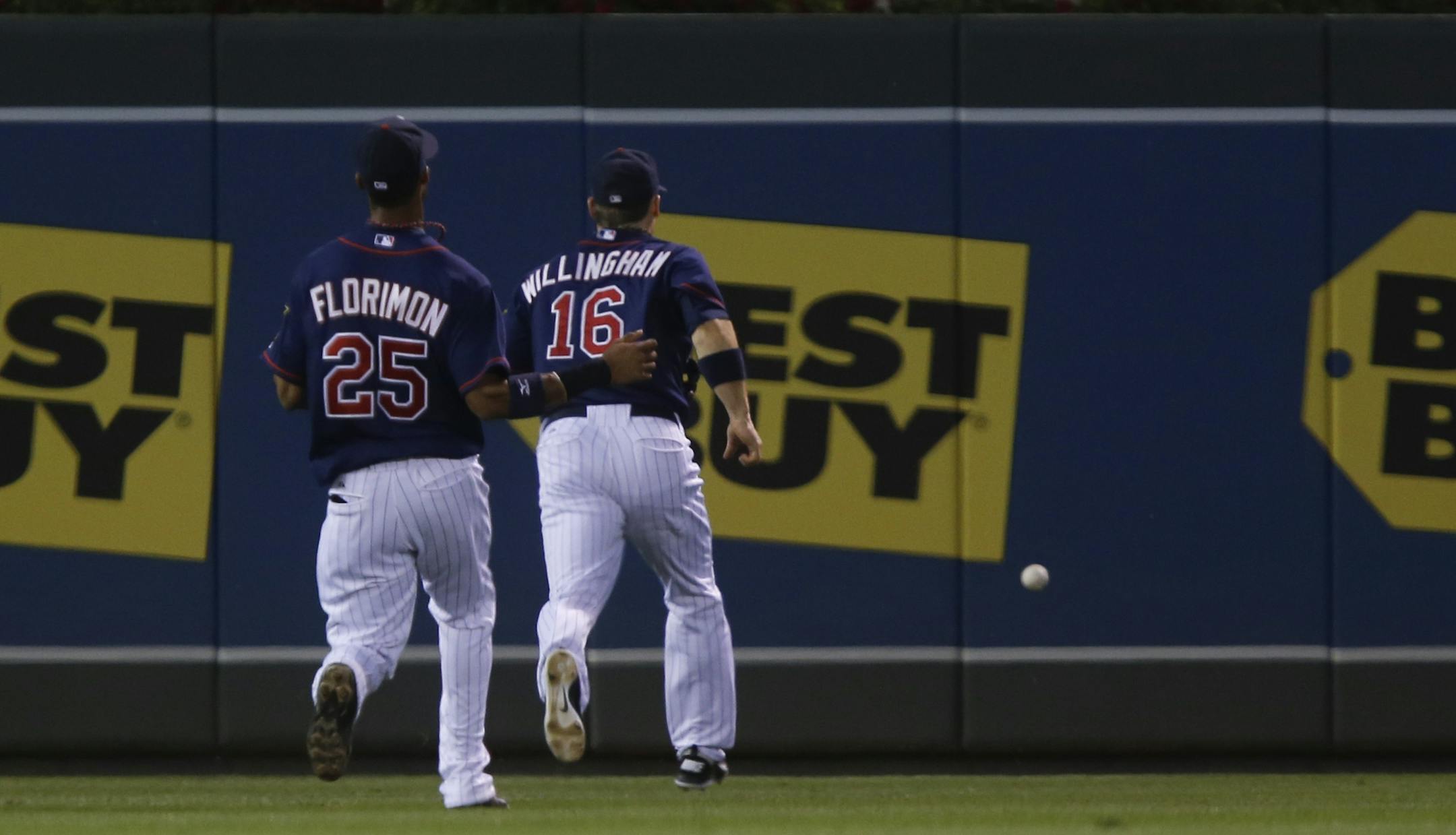Twins left fielder Josh Willingham and shortstop Pedro Florimon chased down a ball Willingham lost in the lights in the second inning Tuesday at Target Field that allowed a run to score.