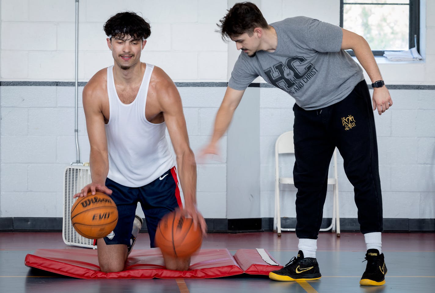 Dawson Garcia, an incoming transfer for the Gophers from North Carolina, via Marquette and Prior Lake, practices with a the "Hoops and Christ" training team, including Dolan Tierney, right, at a North Minneapolis gym in Minneapolis, Minn., on Tuesday, May 24, 2022. ] Elizabeth Flores • liz.flores@startribune.com