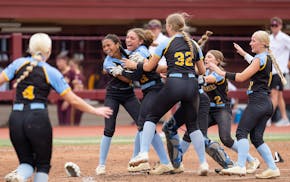 St. Cloud Cathedral players celebrate after defeating Hawley 7-2 in the Class 2A championship game Friday at Jane Sage Cowles Stadium.