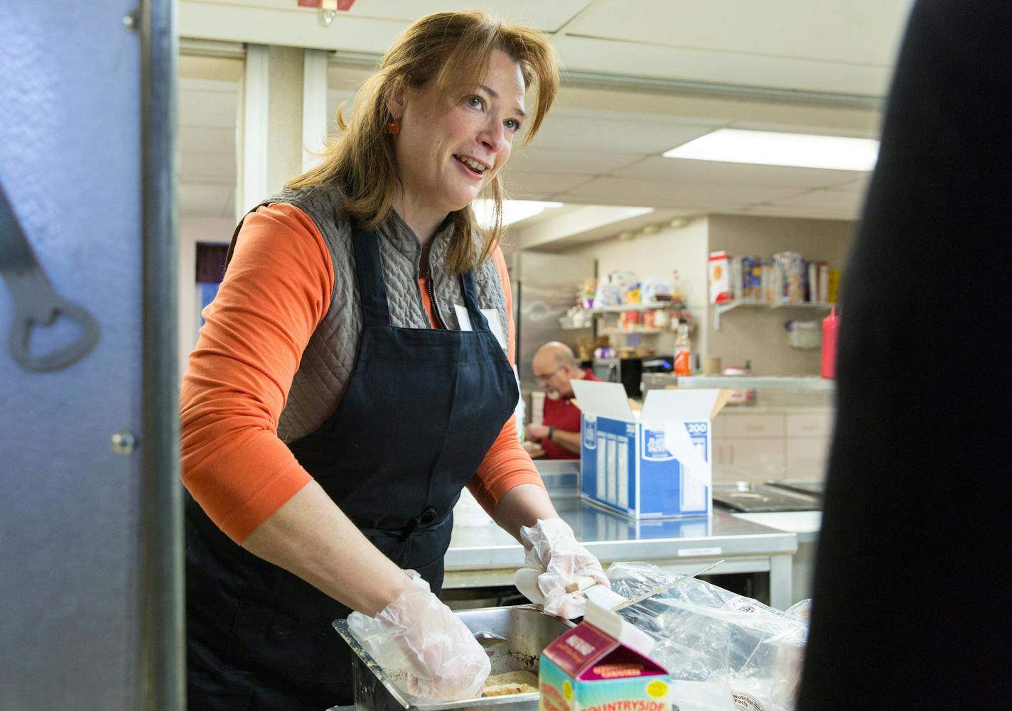 Laurie Halverson, Eagan's state representative, serves food provided by Kabomelette food truck and Chef Lucas Foods at the Dakota Woodlands, Wednesday morning. ] Elizabeth Brumley special to the Star Tribune Intern. * Chef Lucas Foods foudned by Lucas Hobbs, 13, began after his Make-A-Wish to give away free food to people with a foodtruck.