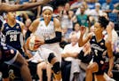 Connecticut Sun defenders Alex Bentley left and Jasmine Thomas put pressure on Maya Moore as she drove to the basket at Target Center on Wednesday.
