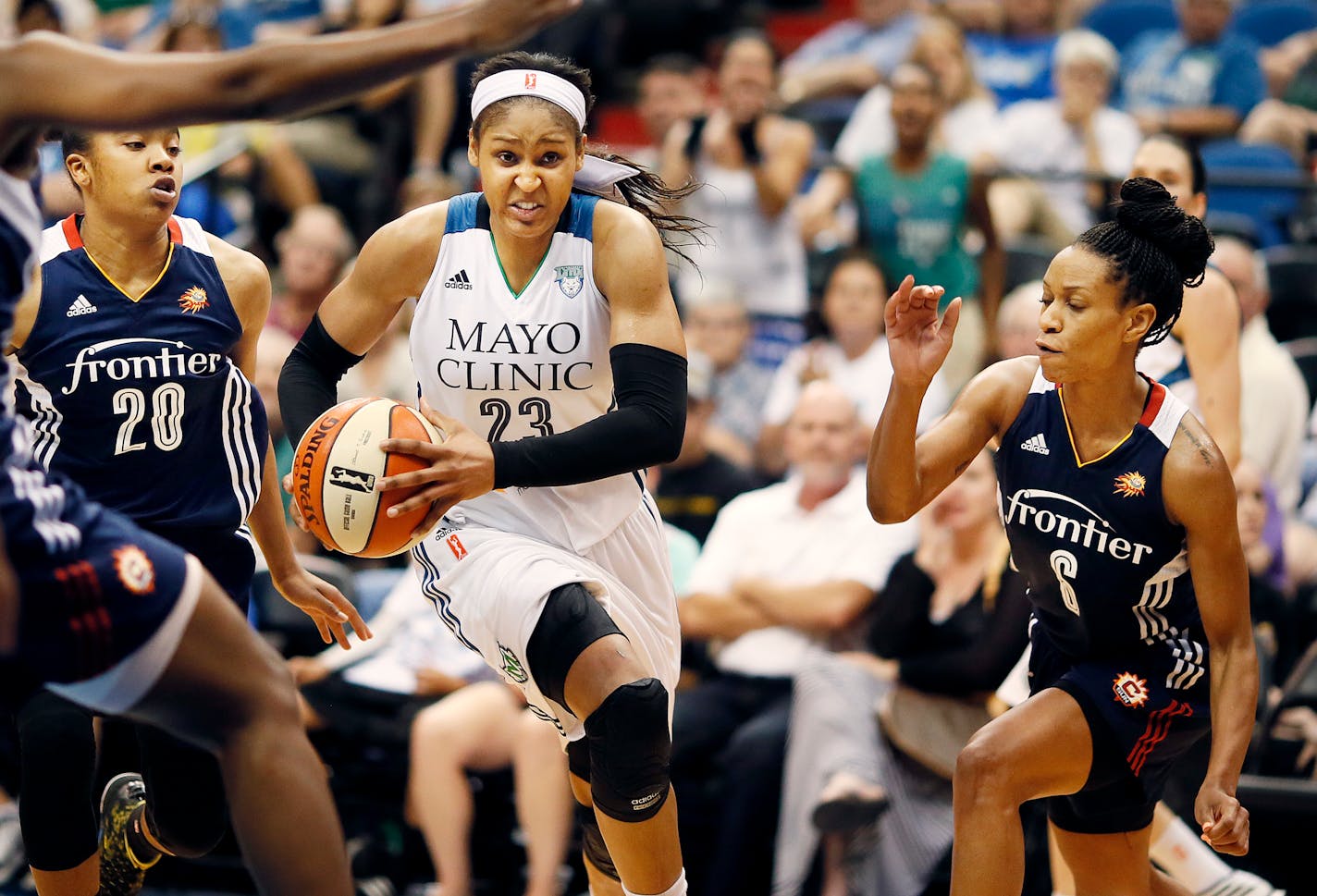 Connecticut Sun defenders Alex Bentley left and Jasmine Thomas put pressure on Maya Moore as she drove to the basket at Target Center on Wednesday.