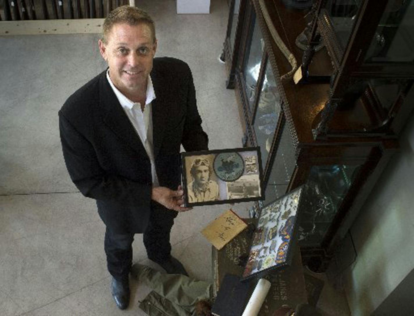 Brian Witherell shows off some collectible items from World War II that were part of a Western Arts auction earlier this year. (Hector Amezcua/Sacramento Bee/TNS) ORG XMIT: 1215828