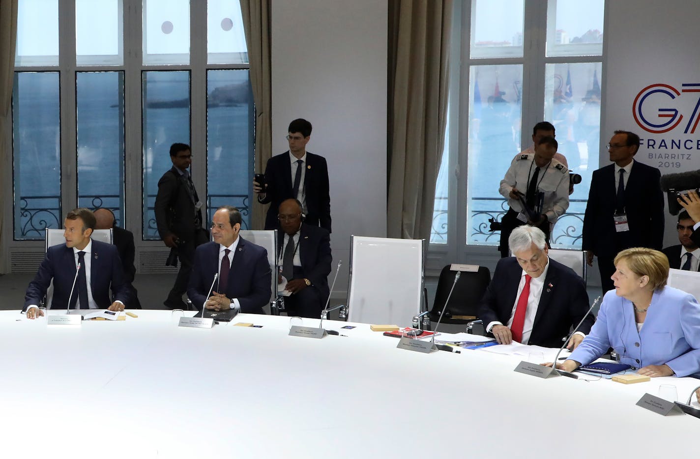 From the left, French President Emmanuel Macron, Egyptian President and Chairman of the African Union Abdel Fattah al-Sissi, Chile's President Sebastian Pinera and German Chancellor Angela Merkel attend a work session focused on climate in Biarritz, southwestern France, Monday Aug. 26, 2019, on the third day of the annual G7 Summit. The empty seat at third right was the place reserved for President Donald Trump, who according to Macron had skipped Monday's working session on the climate. At the