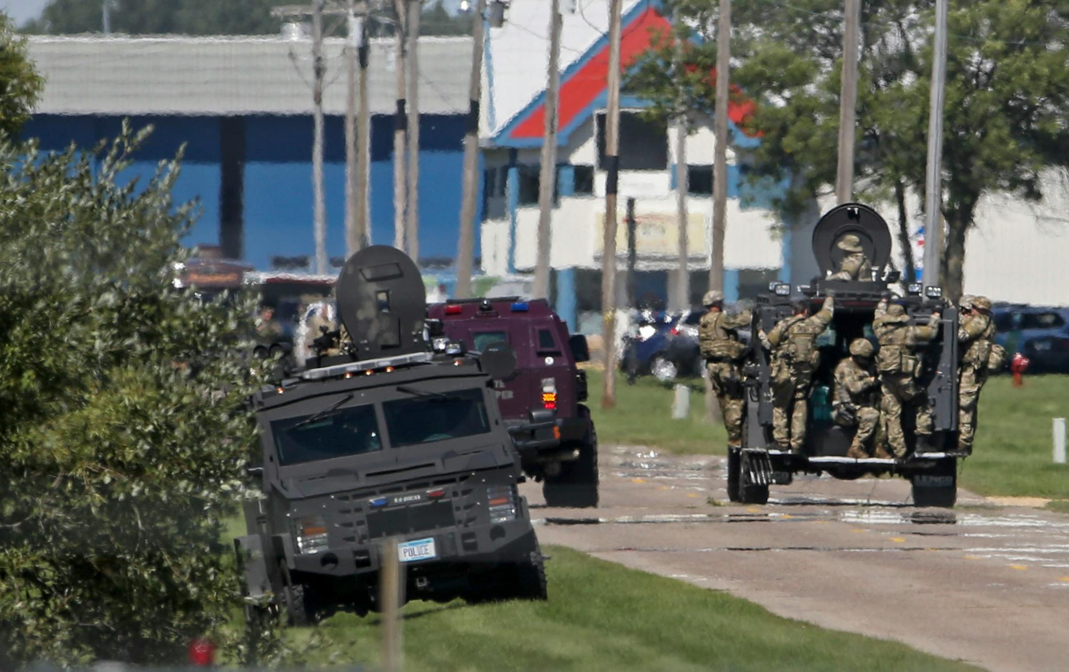 The search for fugitive Ty Hoffman continues around the Anoka County Airport Tuesday, Sept. 2, 2014, in Blaine, MN. Here, after searching a wooded area, SWAT team members head back to the command center at the Anoka County Airport.] (DAVID JOLES/STARTRIBUNE)djoles@startribune.com The search for fugitive Ty Hoffman continues around the Anoka County Airport Tuesday, Sept. 2, 2014, in Blaine, MN.