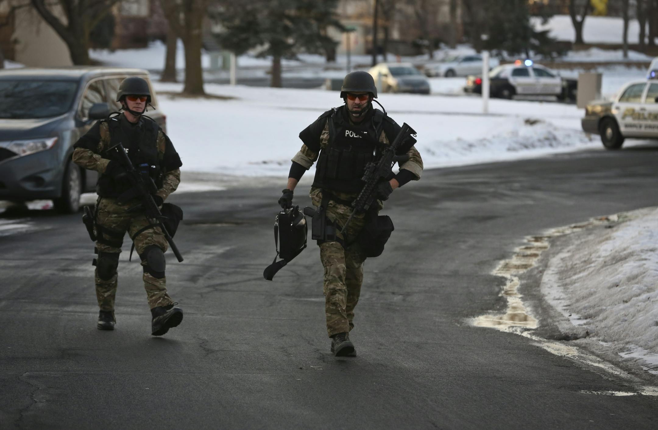 Swat team officers arrived to the scene of a man held up alone in a townhouse with a shotgun on Friday, January 18, 2013, in Maple Grove, Minn.