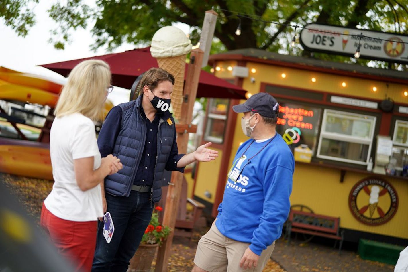 Congressman Dean Phillips walked with Dean Salita, owner of Tommy's Tonka Trolley as he campaigned around Excelsior, Minnesota with Rep. Kelly Morrison, DFL-Deephaven, left.