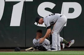 Twins center fielder Byron Buxton (left, being checked by right fielder Max Kepler after Buxton ran into the outfield wall May 26 in Seattle) was rein