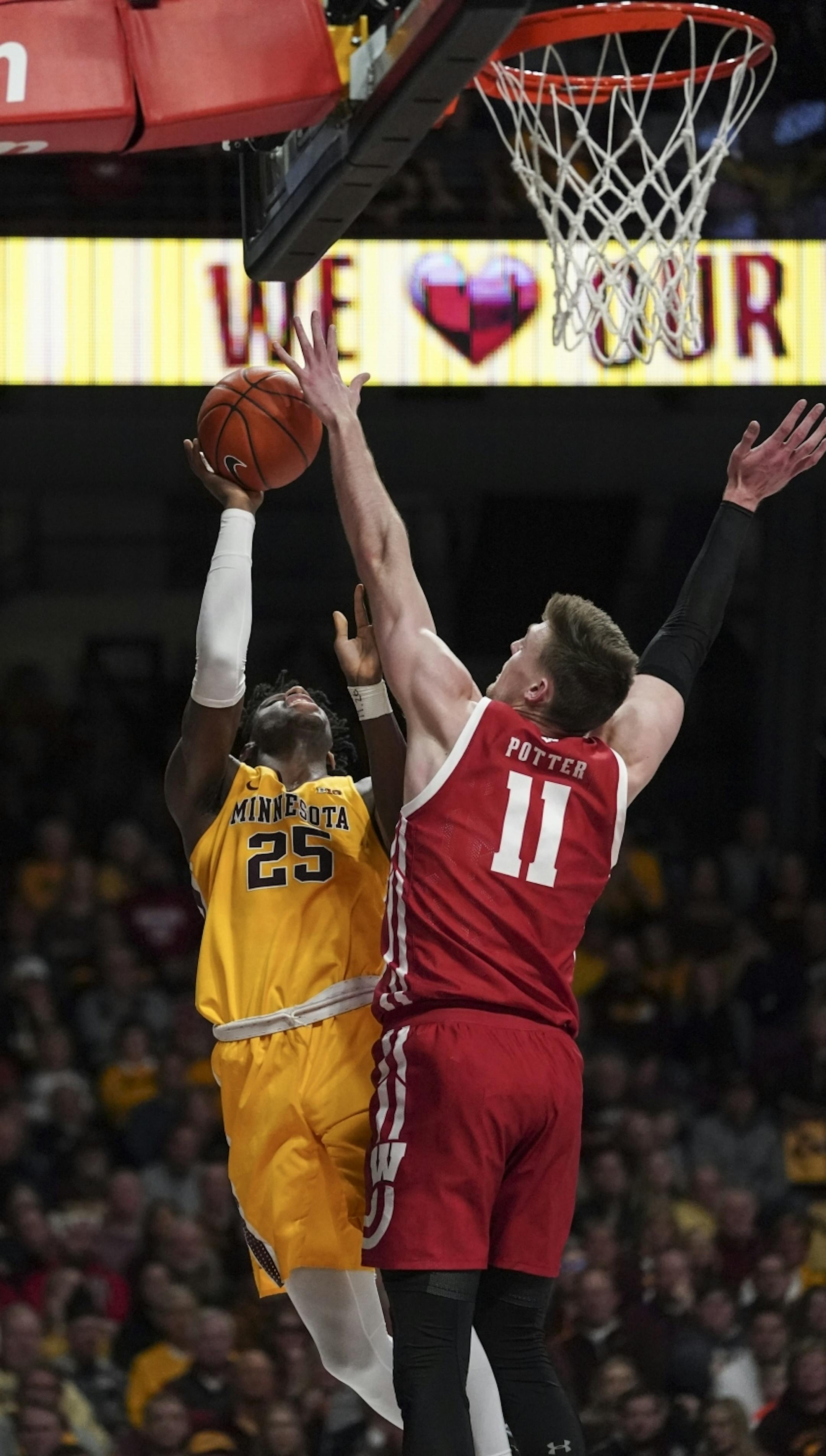Minnesota Gophers center Daniel Oturu (25) attempted a shot against Wisconsin Badgers forward Micah Potter (11) in the second half.