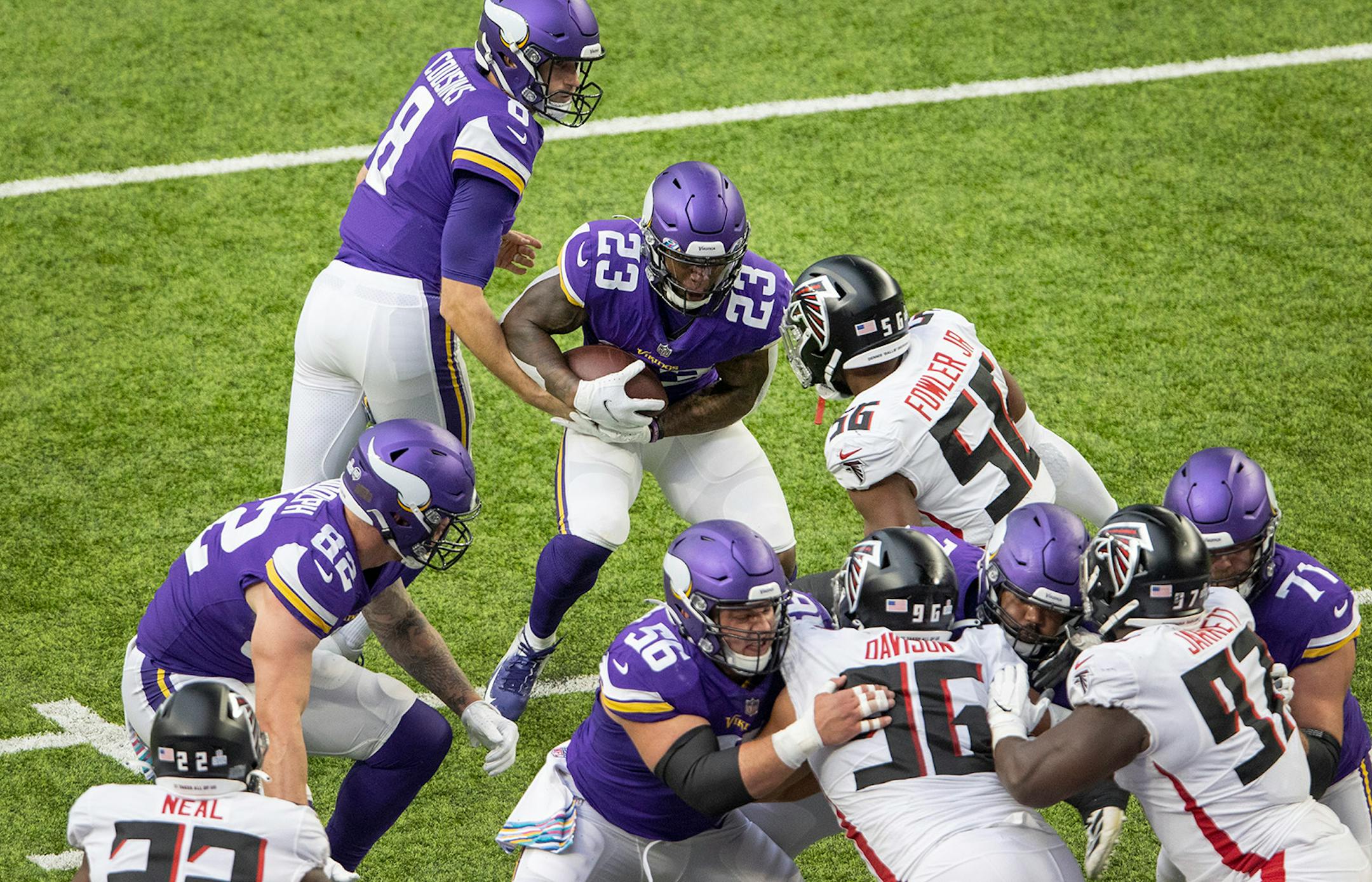 Minnesota Vikings running back Mike Boone (23) was met in the backfield by Dante Fowler Jr. (56) of the Atlanta Falcons on fourth and goal in the second quarter.