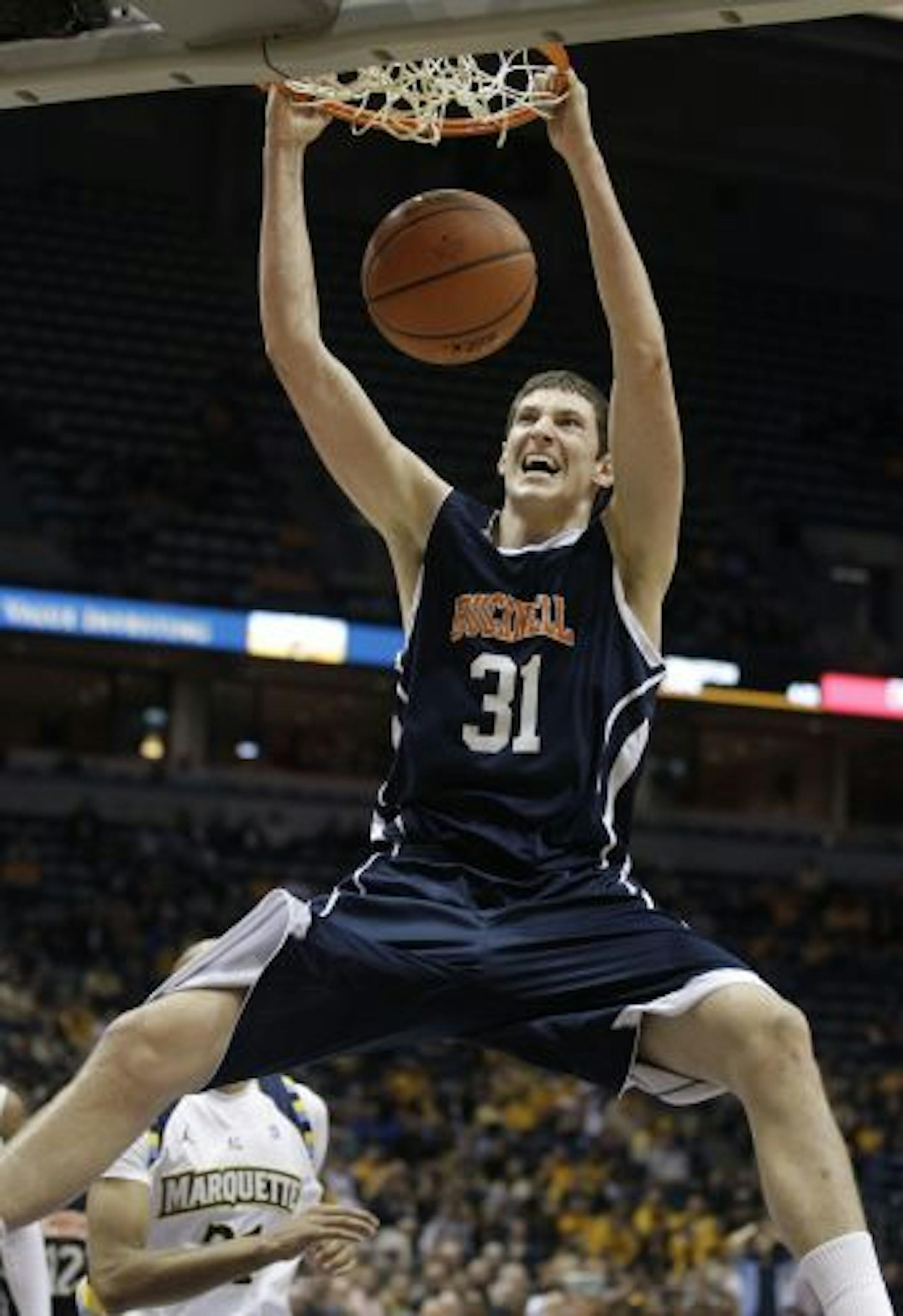 Bucknell's Mike Muscala dunks during the second half of an NCAA college basketball game against Marquette on Sunday, Nov. 14, 2010, in Milwaukee.