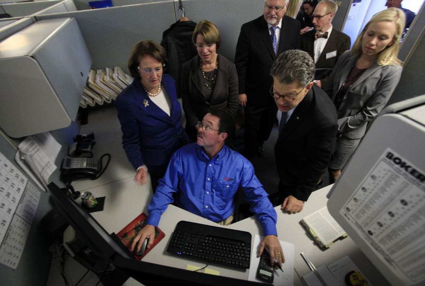 Engineer Dave Belden answered a question from Small Business Administration head Karen Mills, left, during a tour of the Delkor Systems facility on Monday as senators Amy Klobuchar and Al Franken looked on. Behind Franken was Katie Clark, executive director of the Minnesota Trade Office.