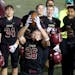 Following his team's 28-0 win over White Bear Lake, Maple Grove running back Evan Hull (26) spun around to the delight of teammates Friday, Oct. 26, 2