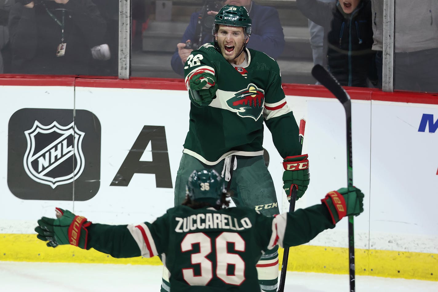 Minnesota Wild right wing Ryan Hartman (38) celebrates with teammate right wing Mats Zuccarello (36) after Hartman scored a goal during the third period of an NHL hockey game against the Colorado Avalanche, Sunday, March 27, 2022, in St. Paul, Minn. Minnesota won 3-2 in overtime. (AP Photo/Stacy Bengs)