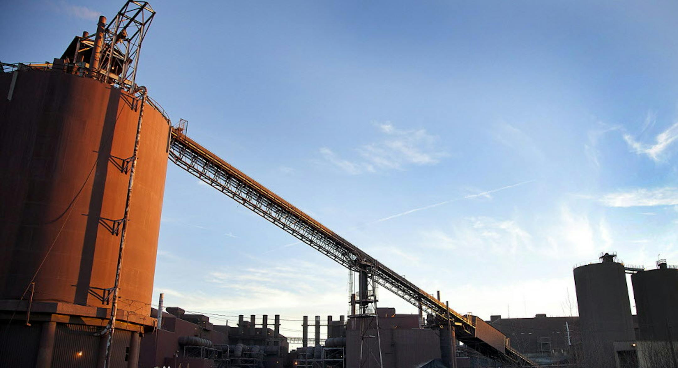 Pellet load-out bins stand at the back of the Hibbing Taconite Co. pellet manufacturing plant, operated by Cliff's Natural Resources Inc., in Hibbing, Minnesota, U.S., on Thursday, Jan. 5, 2012. Taconite is a sedimentary rock containing low-grade iron ore, which is eventually processed into small pellets that contain approximately 65 percent iron. Photographer: Ariana Lindquist/Bloomberg ORG XMIT: 136631014 ORG XMIT: MIN1208291147323654