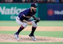 Minnesota Twins closer Sergio Romo crouches over at the front of the mound after walking Texas Rangers' Shin-Soo Choo during the ninth inning of a bas