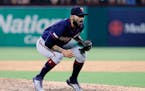 Minnesota Twins closer Sergio Romo crouches over at the front of the mound after walking Texas Rangers' Shin-Soo Choo during the ninth inning of a bas