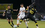 Minnesota United forward Luis Amarilla worked between Columbus players in July in the MLS is Back bubble in Florida.