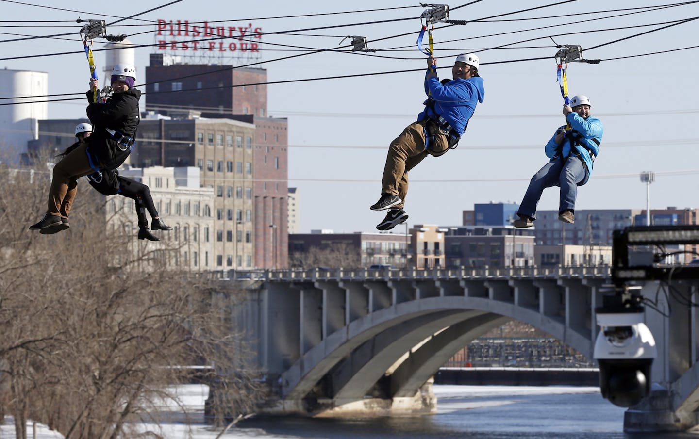 Zipline enthusiasts including politicians, celebrities and media, cross the Mississippi River in Minneapolis Friday, Jan. 26, 2018 as the 10-day Bold North theme festival got underway, one of many events leading up to the Super Bowl.