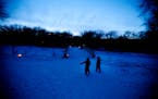Two kids enjoyed their walk with their family during a candlelit outing at a Minnesota state park.