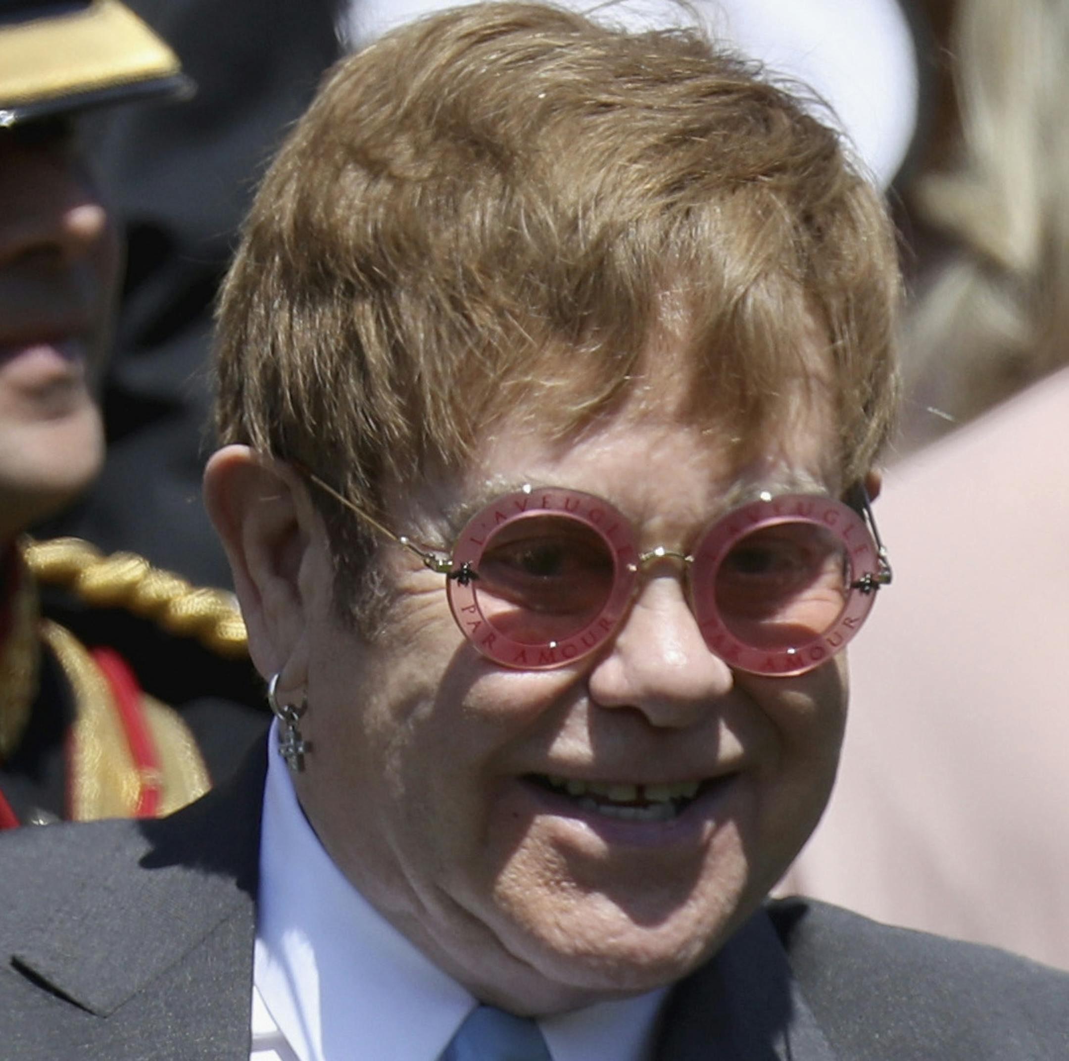 Sir Elton John waves arrives for the wedding ceremony of Prince Harry and Meghan Markle at St. George's Chapel in Windsor Castle in Windsor, near London, England, Saturday, May 19, 2018. (Chris Jackson/pool photo via AP)