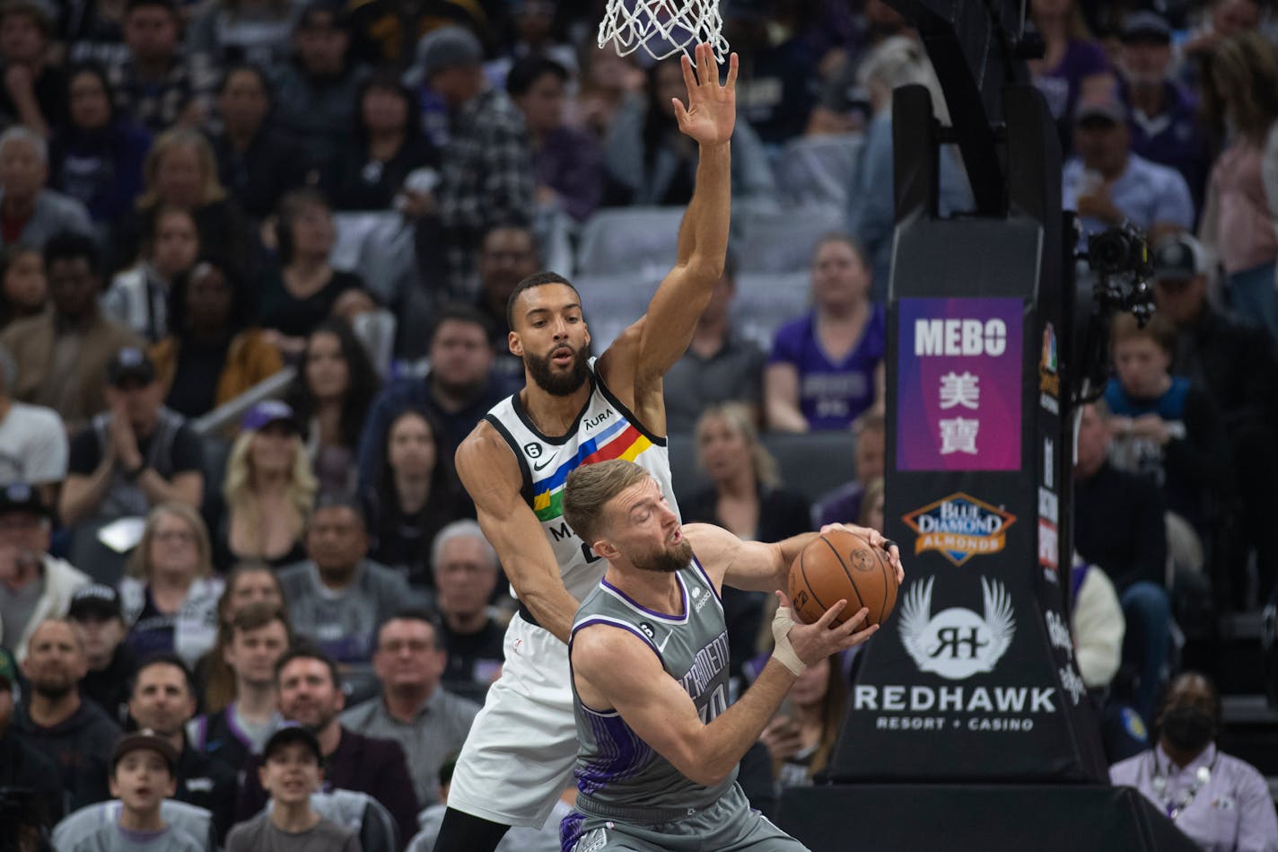 Sacramento Kings forward Domantas Sabonis (10) is defended by Minnesota Timberwolves center Rudy Gobert (27) in the first quarter in an NBA basketball game in Sacramento, Calif., Monday, March 27, 2023. (AP Photo/José Luis Villegas)