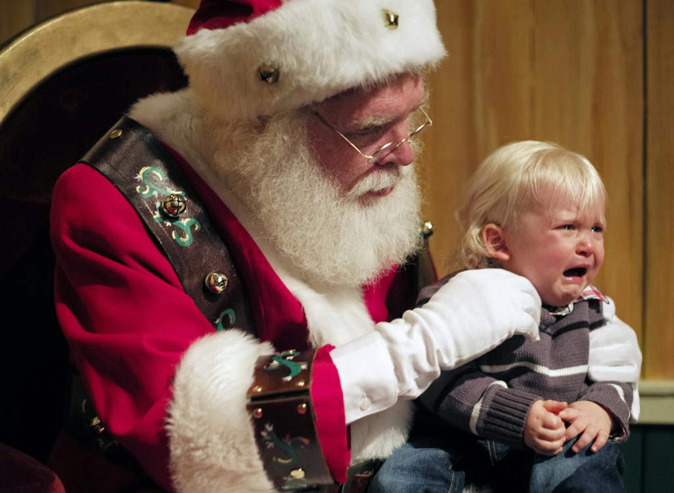 Santa Claus, aka Steve Graves, tried to get 18-month-old Landen Wilber of Cottage Grove to reveal his Christmas wish list, but the event was too much for Landen.