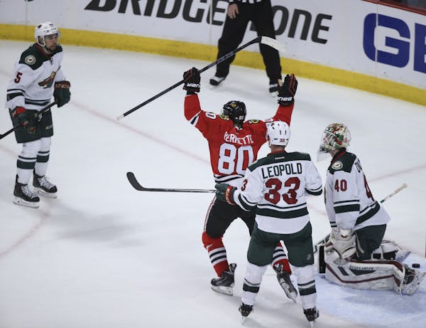 The Chicago Blackhawks' Antoine Vermette (80) celebrates what proved to be the game-winning goal by teammate Teuvo Teravainen, not pictured, in the se