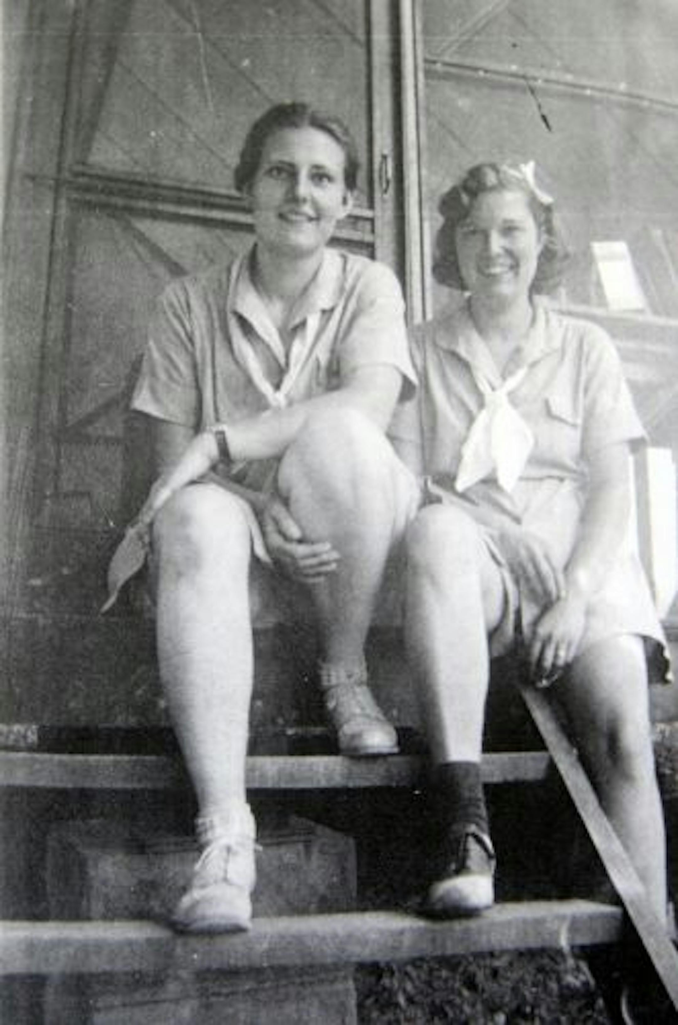 Girl Scout counselors sat on a cabin's stairs during a stay at Camp Greenwood in the 1930s.