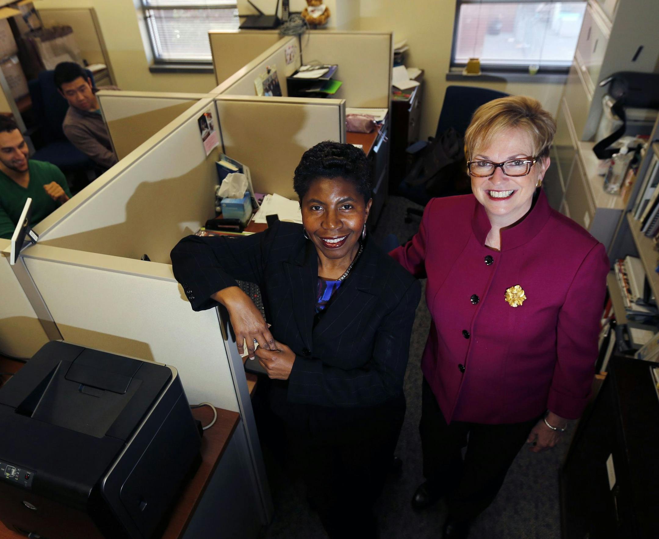 In this Friday, Oct. 16, 2015, photo, Consultants 2 Go co-owners Sandi Webster, center, and Peggy McHale, right, pose for photos in their office in Newark, N.J. The compnay, which has nearly 100 employees, hired a human resources executive this year to do the research into health insurance plans. Webster and McHale want to give their staffers good insurance, but are worried about the cost. (AP Photo/Julio Cortez) ORG XMIT: NYBZ171