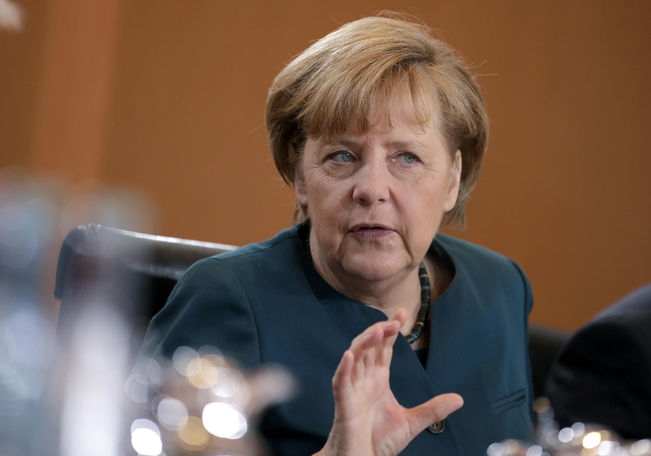 German Chancellor Angela Merkel gestures at the beginning of the weekly cabinet meeting at the chancellery in Berlin, Germany, Wednesday, Jan. 15, 2014. (AP Photo/Michael Sohn)