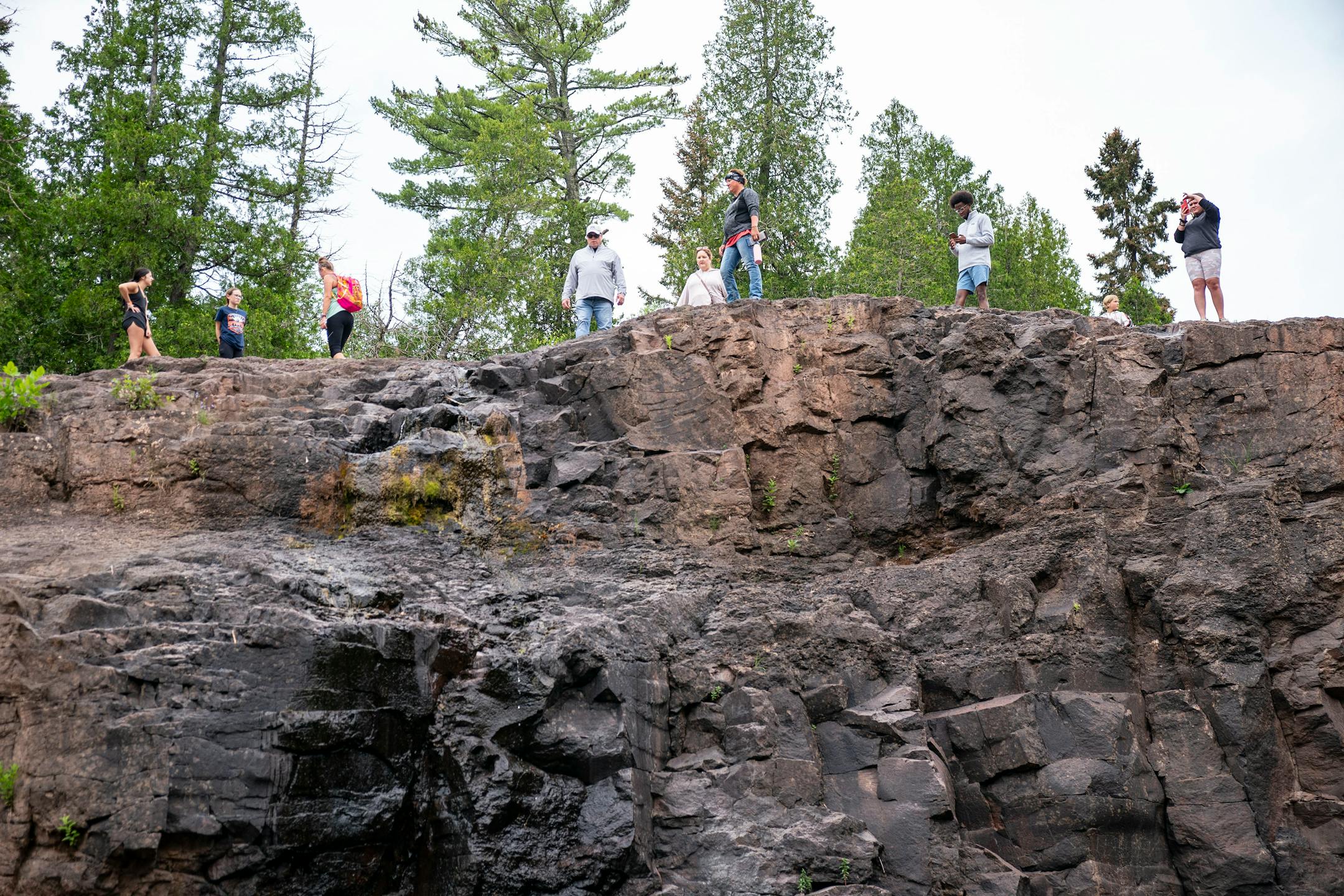 Visitors took pictures on top of a dried up section south of the main falls at Gooseberry Falls State Park on Wednesday, July 21, 2021. Sections of the falls have dried out because of the drought that has plagued the Midwest this summer.