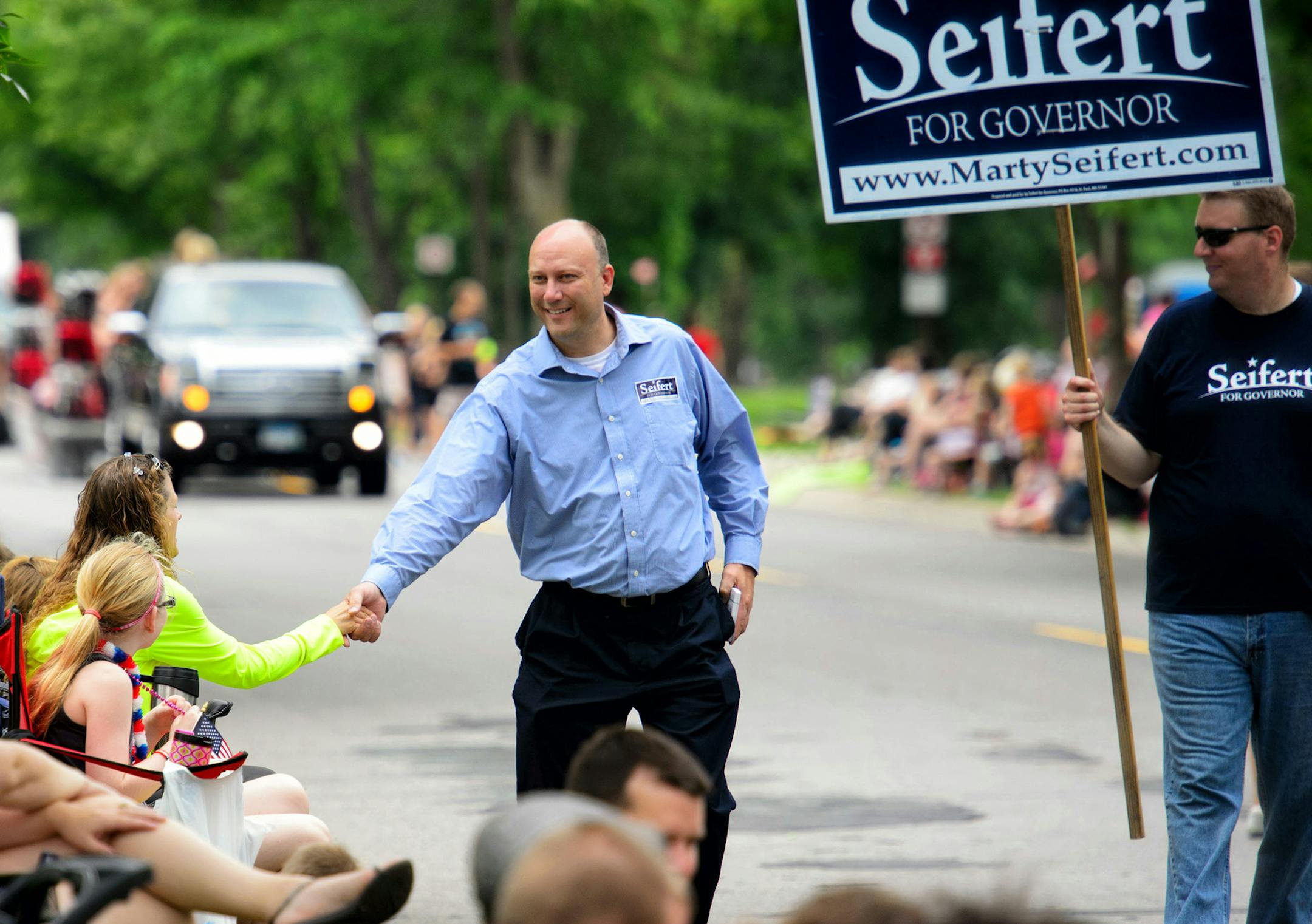Marty Seifert, one of four serious contenders for the GOP primary for governor, greeted people along the parade route at the Granite City Days parade in St. Cloud, Saturday June 28, 2014. ] GLEN STUBBE * gstubbe@startribune.com ORG XMIT: MIN1407071804411484