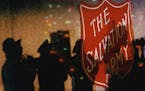 November 28, 1992 And below, shadows of members of the Salvation Army band reflected off the wall of NSP Plaza during the annual lighting of the Salva