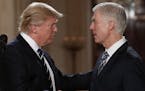 FILE - In this Jan. 31, 2017, file photo, President Donald Trump shakes hands with 10th U.S. Circuit Court of Appeals Judge Neil Gorsuch, his choice f