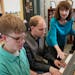 Pianists Noah Johnson (left) and Brandon Leu practiced one of their songs as teacher Diana Bearmon watched and listened. ] Shari L. Gross &#x2022; sha