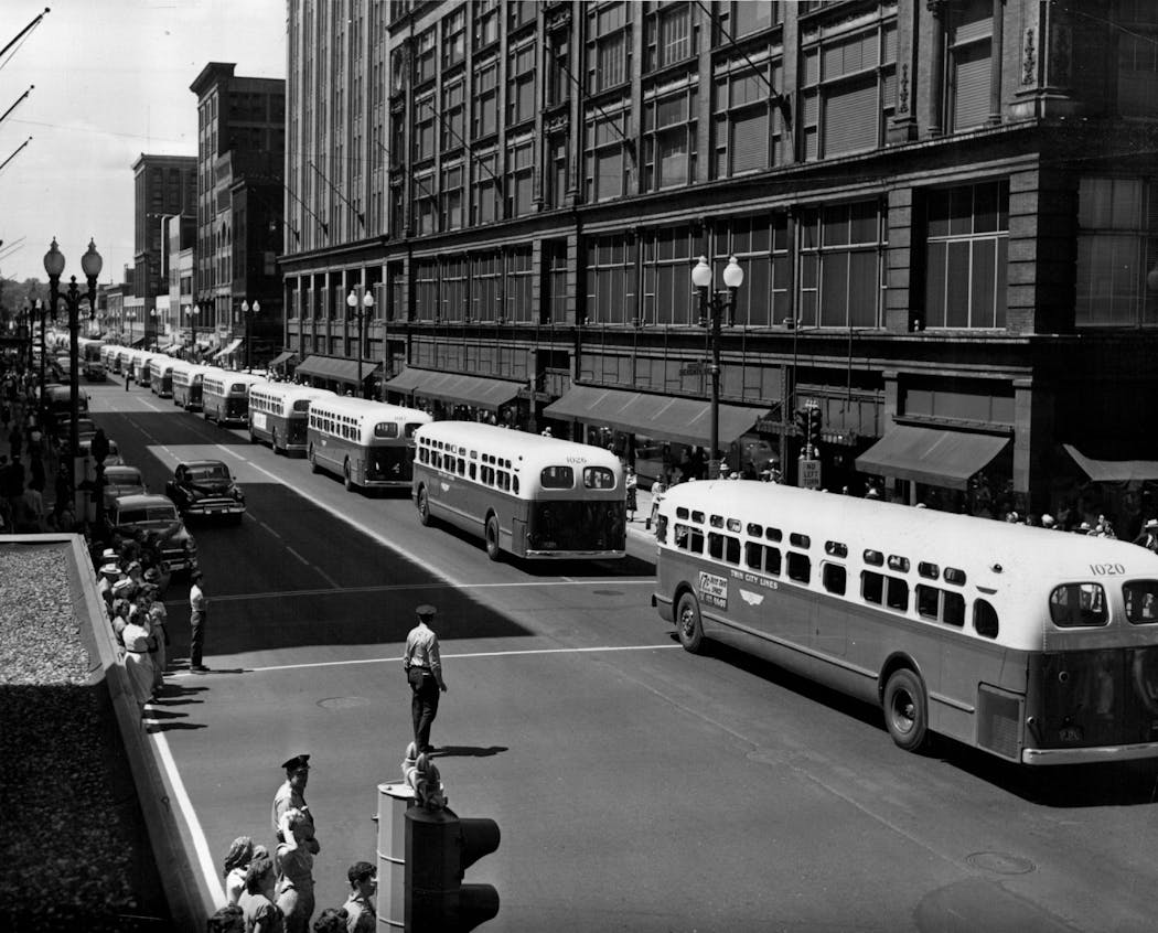 New buses headed south on Nicollet Avenue at 7th Street in 1953.