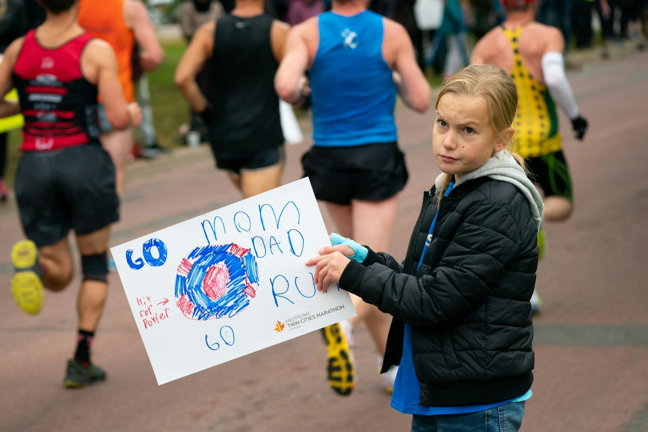 Presley Dubas, 8, waited patiently for her mom Kelia along Minnehaha Ave near the 11 mile mark of the Twin Cities Marathon.