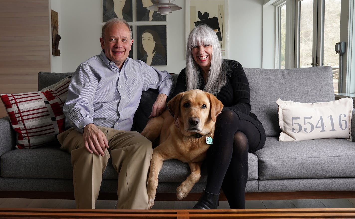 Homeowners David and Cathy Sussman with Max, their yellow Labrador retriever.