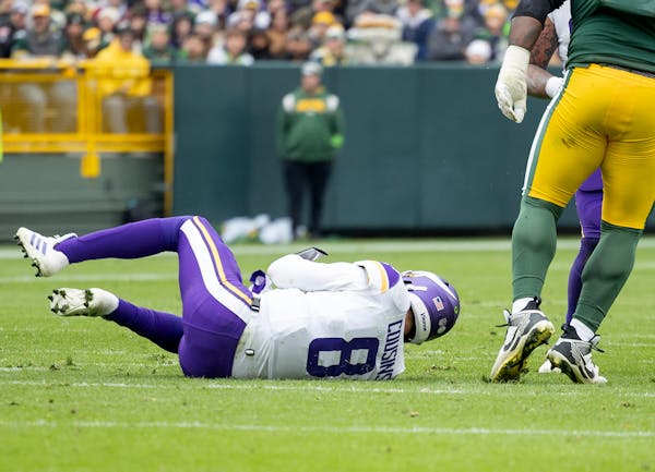 Vikings quarterback Kirk Cousins (8) on the ground after the fourth-quarter non-contact injury in Green Bay on Sunday.