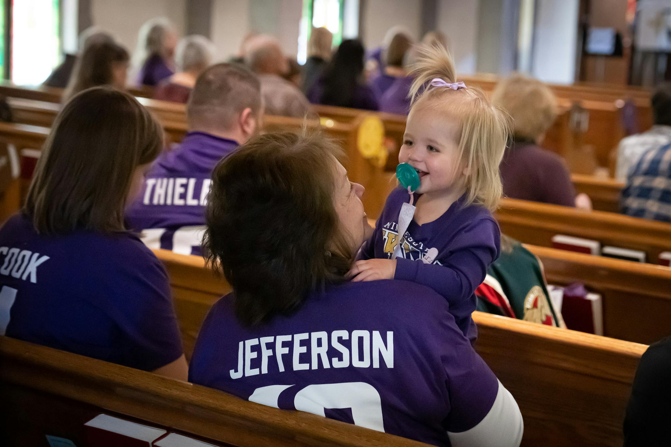 Jana Engdahl rocked her granddaughter Kinsley Karas, 4, during a singing portion of the service.
