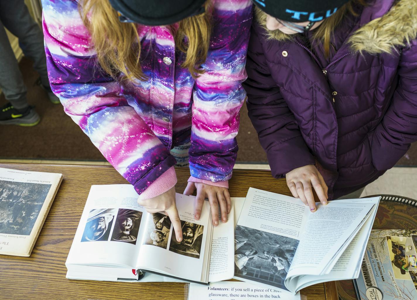 Sixth graders from Tri-City United school in Le Center poured through books about the pioneer photographer and ethnographer Edward S. Curtis at an exhibit in Montgomery, Minn.