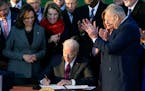 FILE - President Joe Biden signs the $1.2 trillion bipartisan infrastructure bill into law during a ceremony on the South Lawn of the White House in W