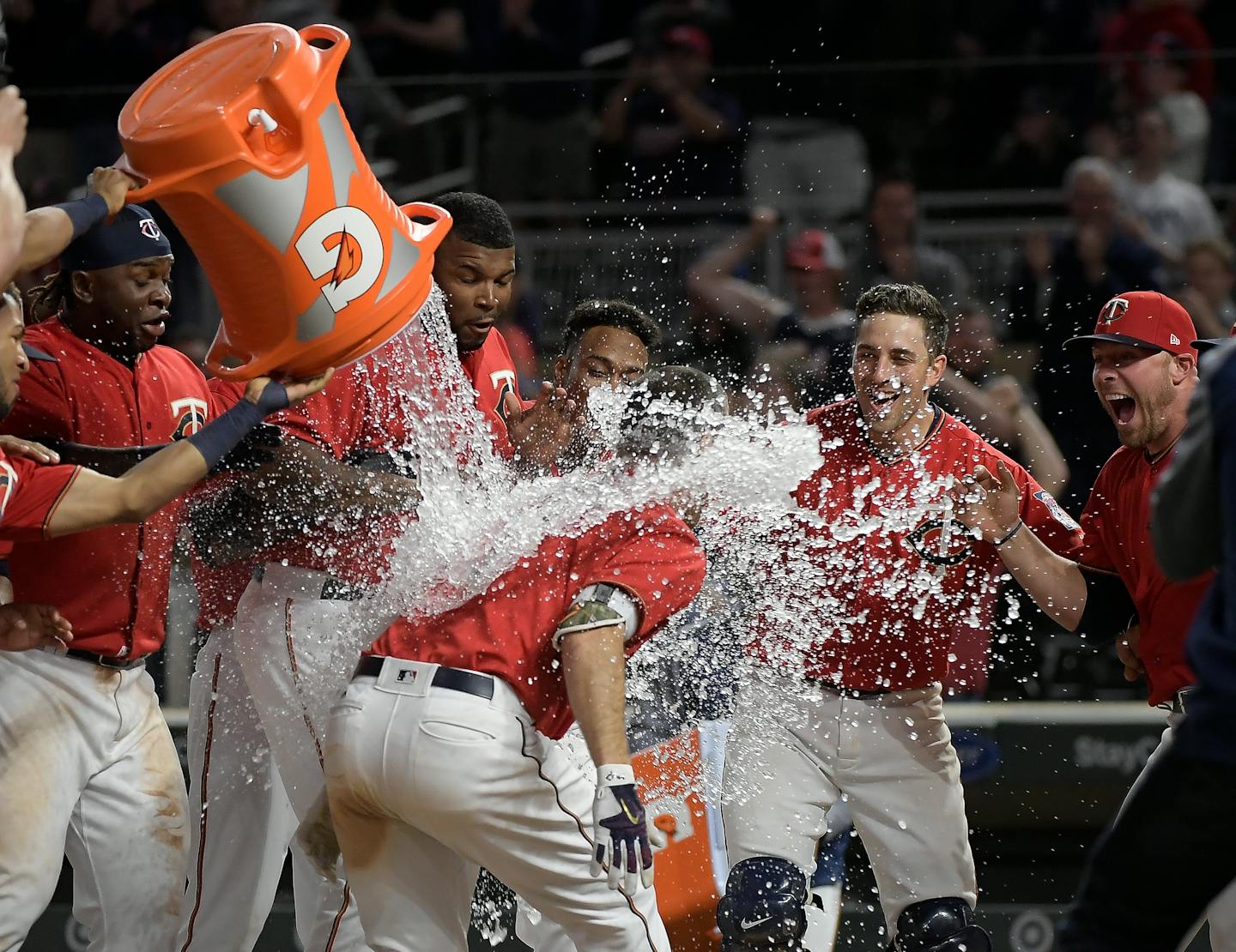 Teammates celebrated with Minnesota Twins first baseman Joe Mauer (7) after he hit a walk off homerun against the Boston Red Sox.