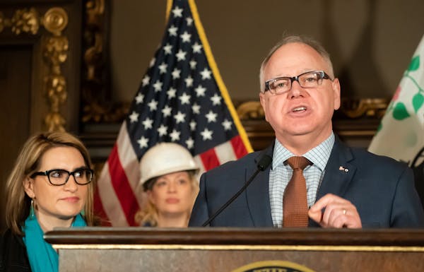 Gov. Tim Walz, at a 2019 press conference on energy and climate policy, has signed a letter urging Congress to take action.