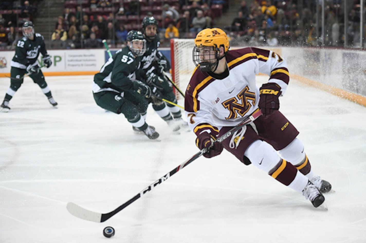 Minnesota Gophers forward Brannon McManus (7) controlled the puck in the third period against Michigan State.