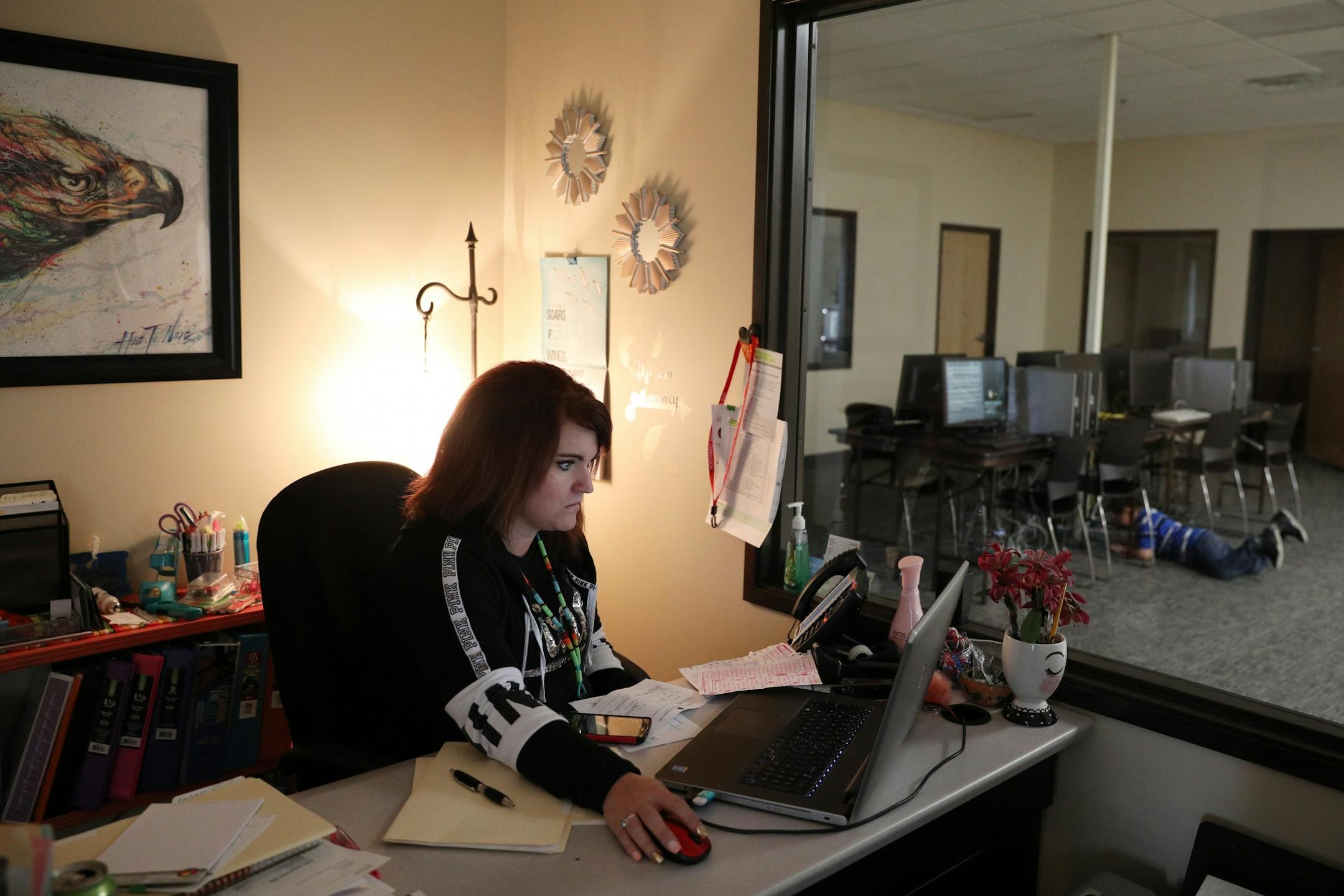 Ashley Benson, a mother of four who went through Sanford Bemidji Medical Center's First Steps program to help pregnant opioid addicts wean off their addictions, worked in her office at the Northwestern Indian Community Development Center in Bemidji as her oldest son Avery Boudreau, 5, played in another room.