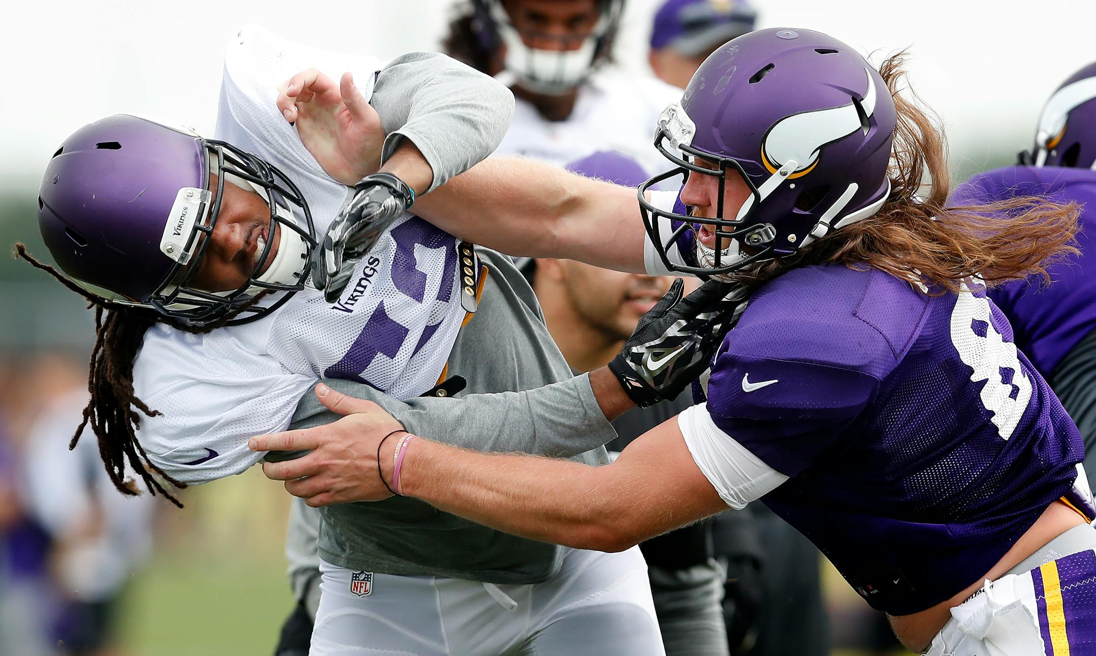 Defensive end Denzell Perine, left, was blocked by tight end David Morgan during the Vikings' afternoon practice in Mankato on Monday.